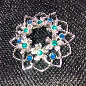 Sarah Coventry silver brooch with cobalt blue and emerald green gems.